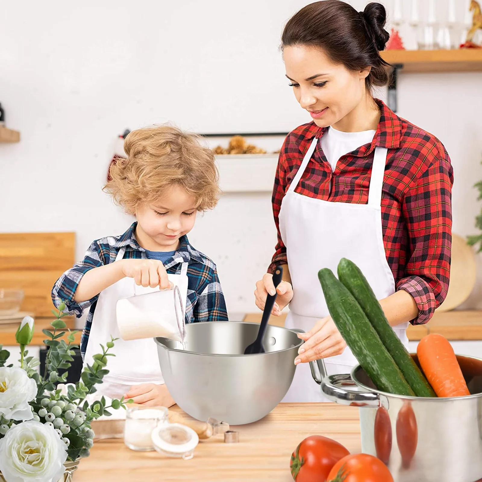 A child pouring milk into a stainless bowl while an adult stirs